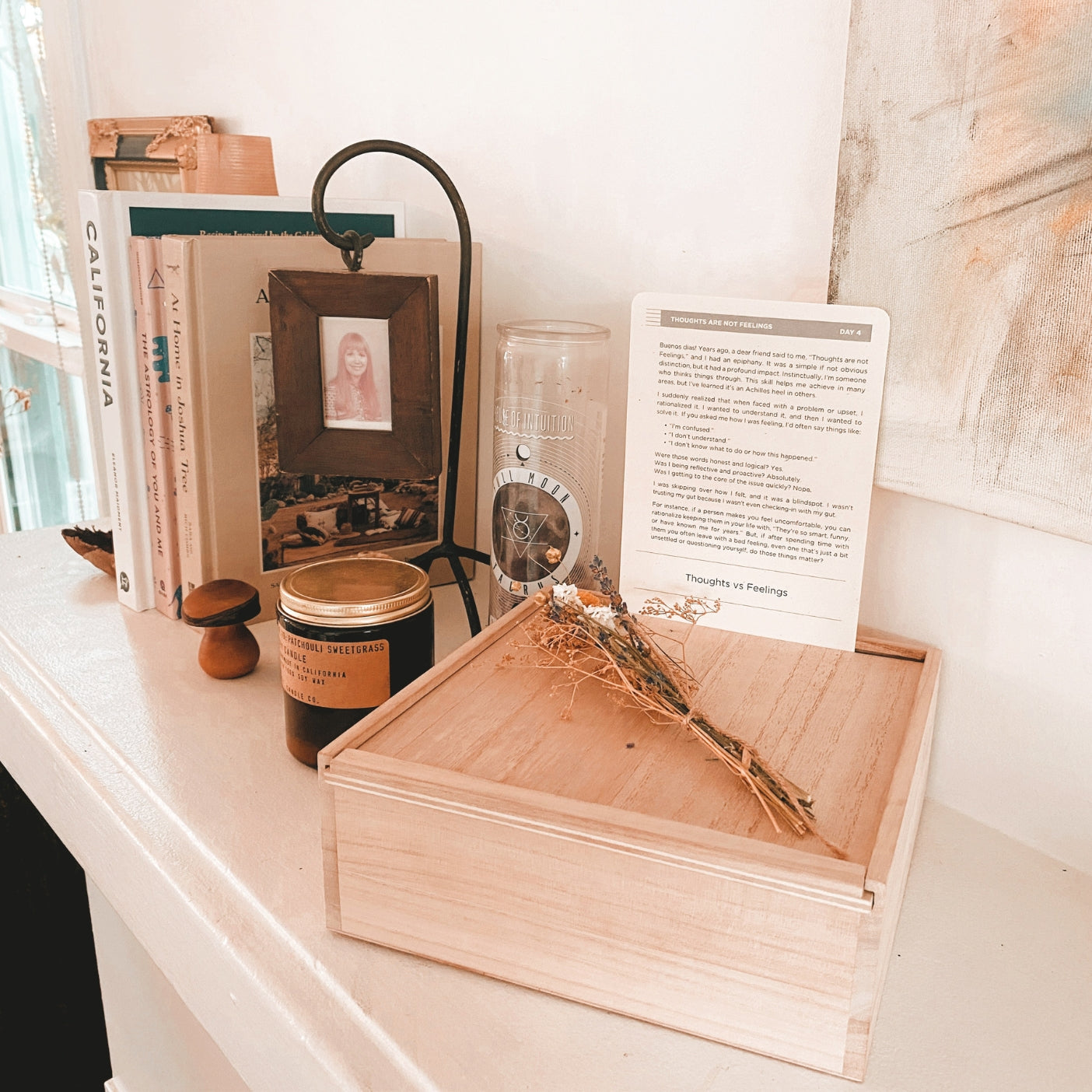 The Comeback Box: wooden box on shelf with dried flowers, candle and books.