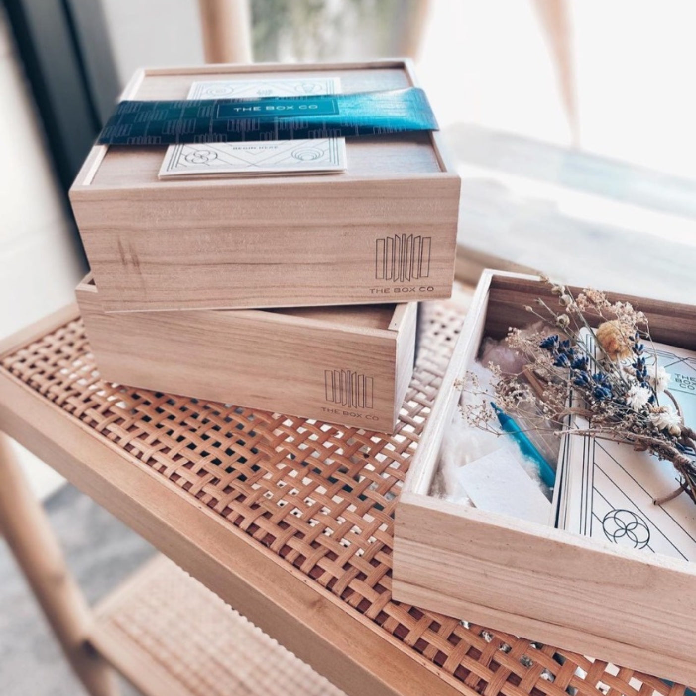 The Comeback Box: wooden boxes stacked, open box with dried flowers.