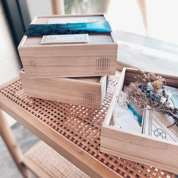 The Box Co: wooden boxes stacked, open box with dried flowers.